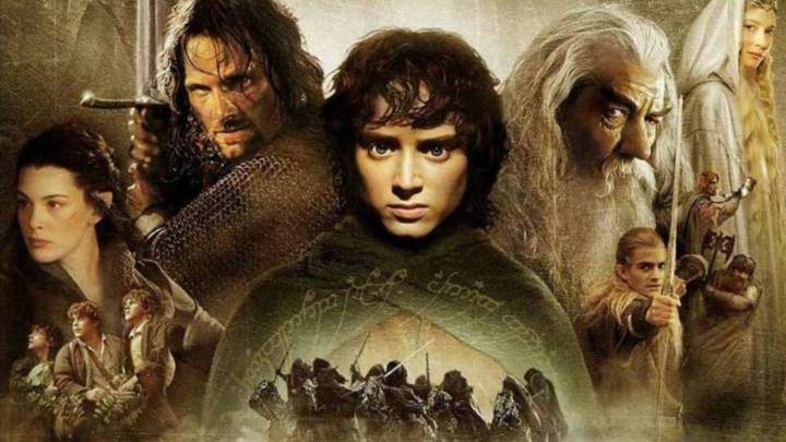 The Lord of the Rings movie poster showing Frodo holding the One Ring, Aragorn with a sword, Gandalf, Legolas, and other members of the Fellowship against a dark fantasy background.